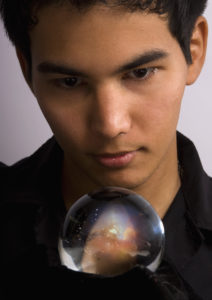 Man stares into a crystal ball to see the future