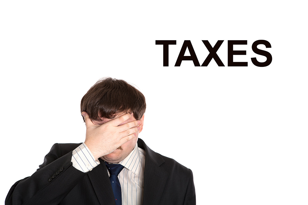 Taxes have a man holding his head